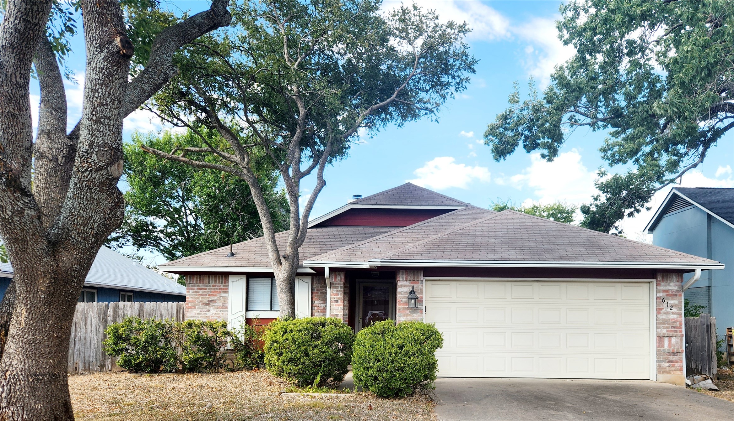 a front view of a house with yard and garage