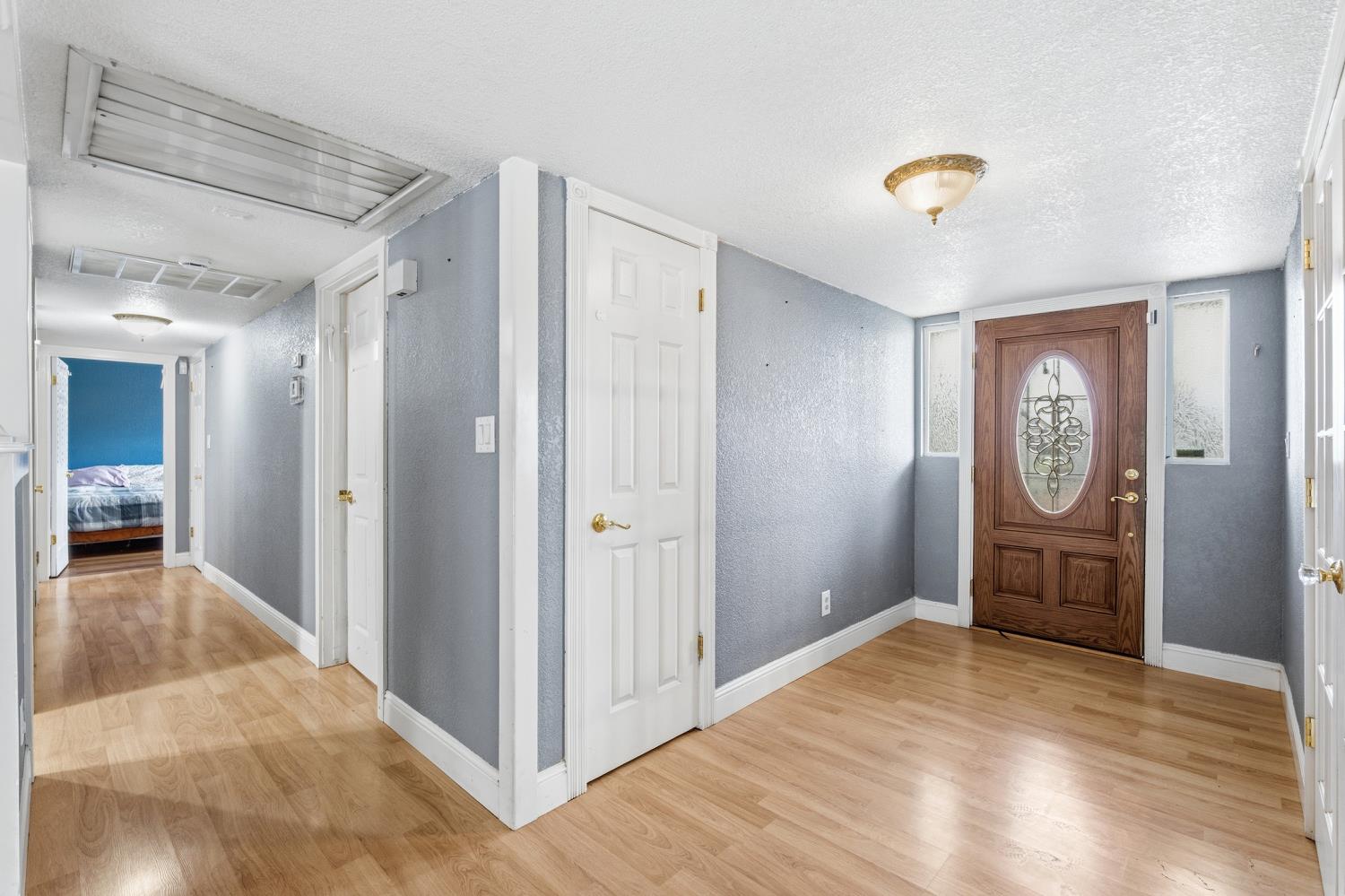 36313 Ave 12 Madera, CA 93636 - Photo 11 of 41 a view of a hallway with wooden floor