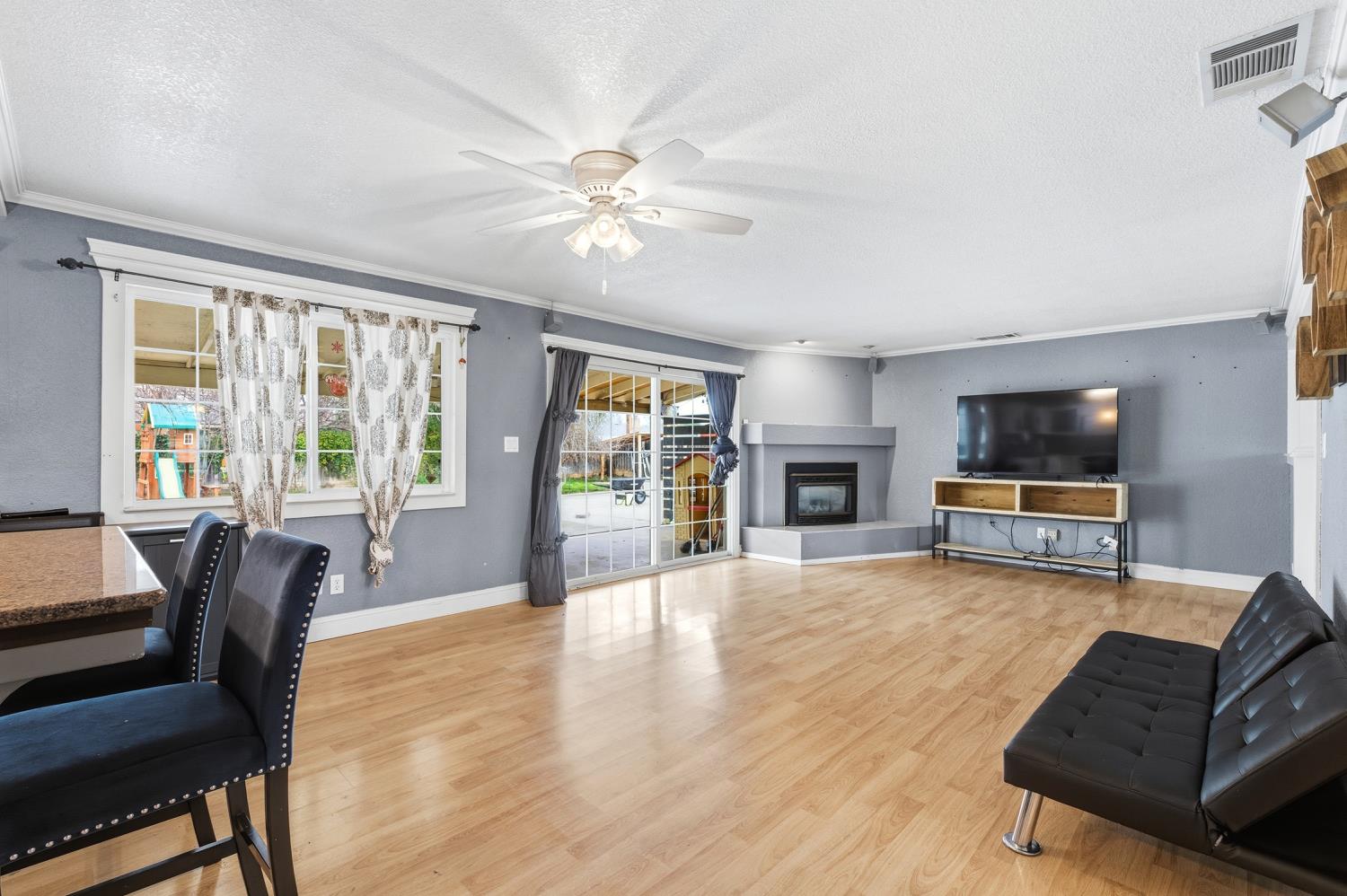 36313 Ave 12 Madera, CA 93636 - Photo 13 of 41 a living room with furniture and a flat screen tv