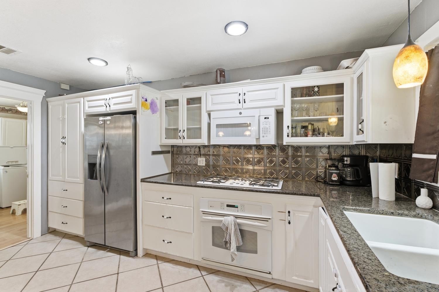 36313 Ave 12 Madera, CA 93636 - Photo 18 of 41 a kitchen with stainless steel appliances granite countertop a sink and cabinets