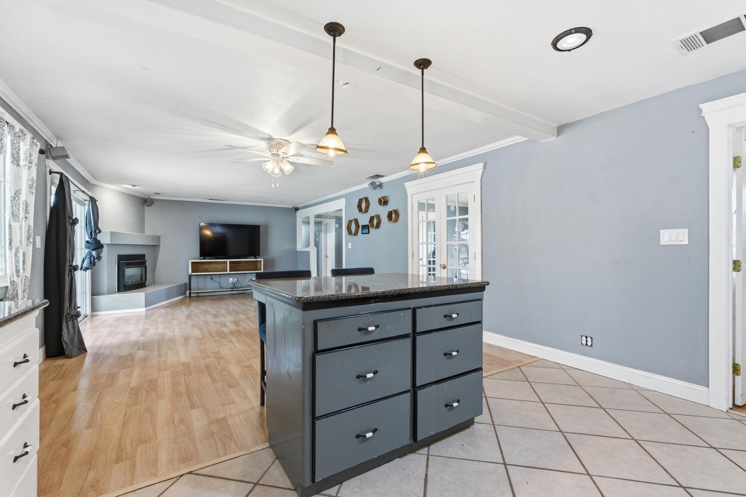 36313 Ave 12 Madera, CA 93636 - Photo 19 of 41 a view of a kitchen with kitchen island a counter top a sink and stainless steel appliances