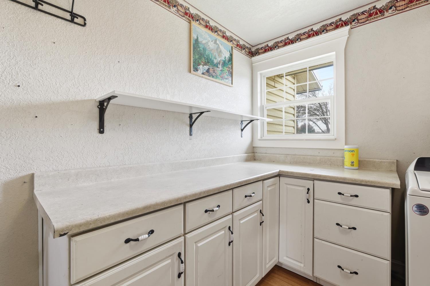 36313 Ave 12 Madera, CA 93636 - Photo 21 of 41 a kitchen with white cabinets and window