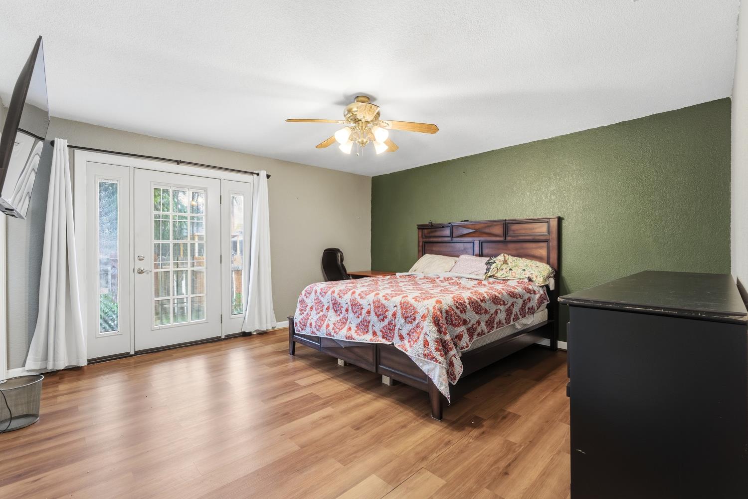 36313 Ave 12 Madera, CA 93636 - Photo 27 of 41 a bedroom with a large bed and a chandelier