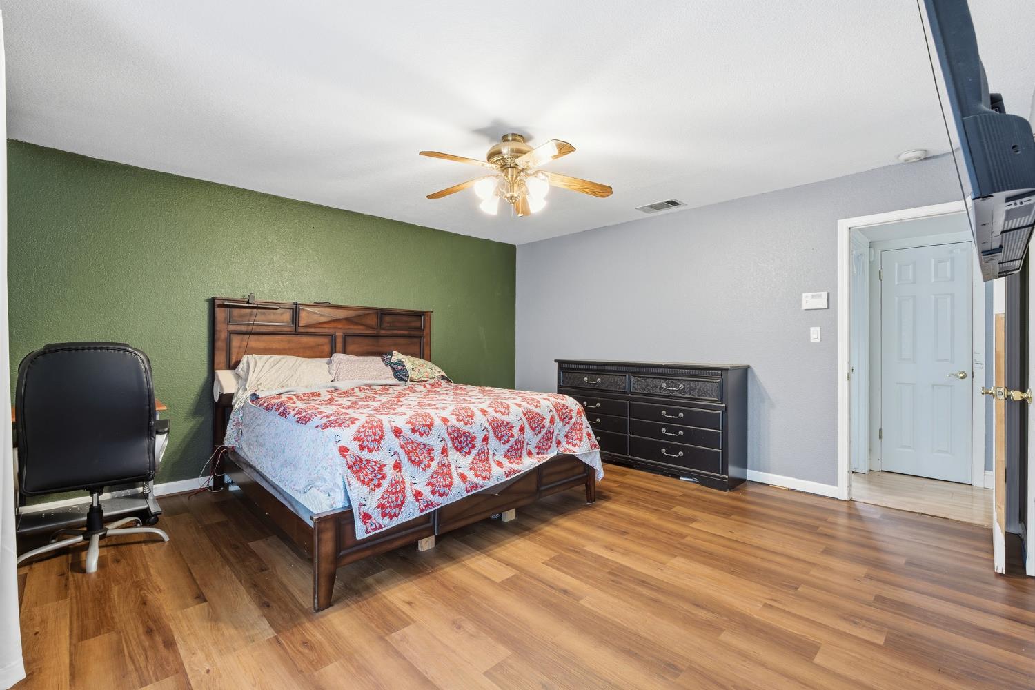 36313 Ave 12 Madera, CA 93636 - Photo 28 of 41 a bedroom with a bed and a potted plant