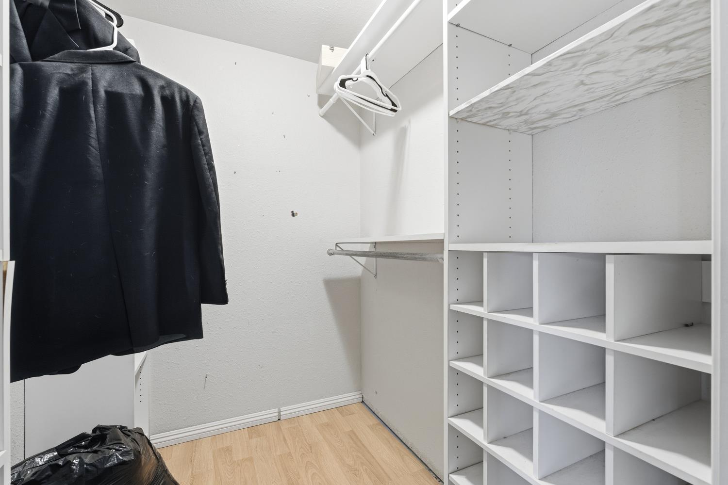 36313 Ave 12 Madera, CA 93636 - Photo 30 of 41 a view of walk in closet with clothes and shoes