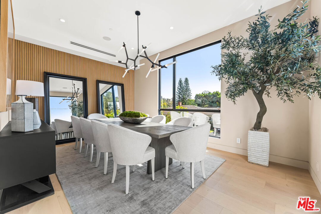 12119 Travis Street Los Angeles, CA 90049 - Photo 1 of 26 a view of a dining room with furniture window and wooden floor