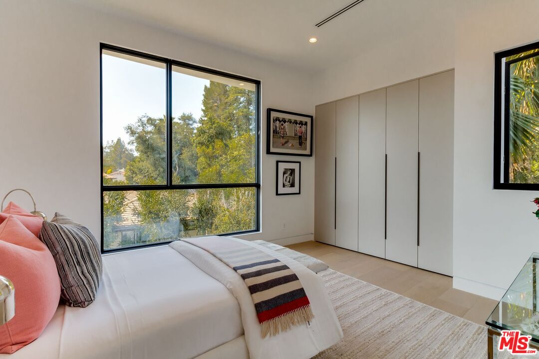 12119 Travis Street Los Angeles, CA 90049 - Photo 11 of 26 a bedroom with a bed and a large window