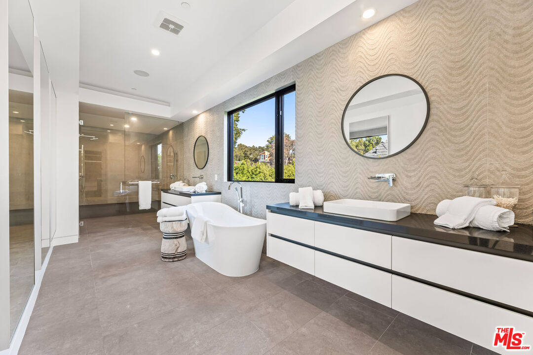 12119 Travis Street Los Angeles, CA 90049 - Photo 17 of 26 a living room with furniture and a large mirror