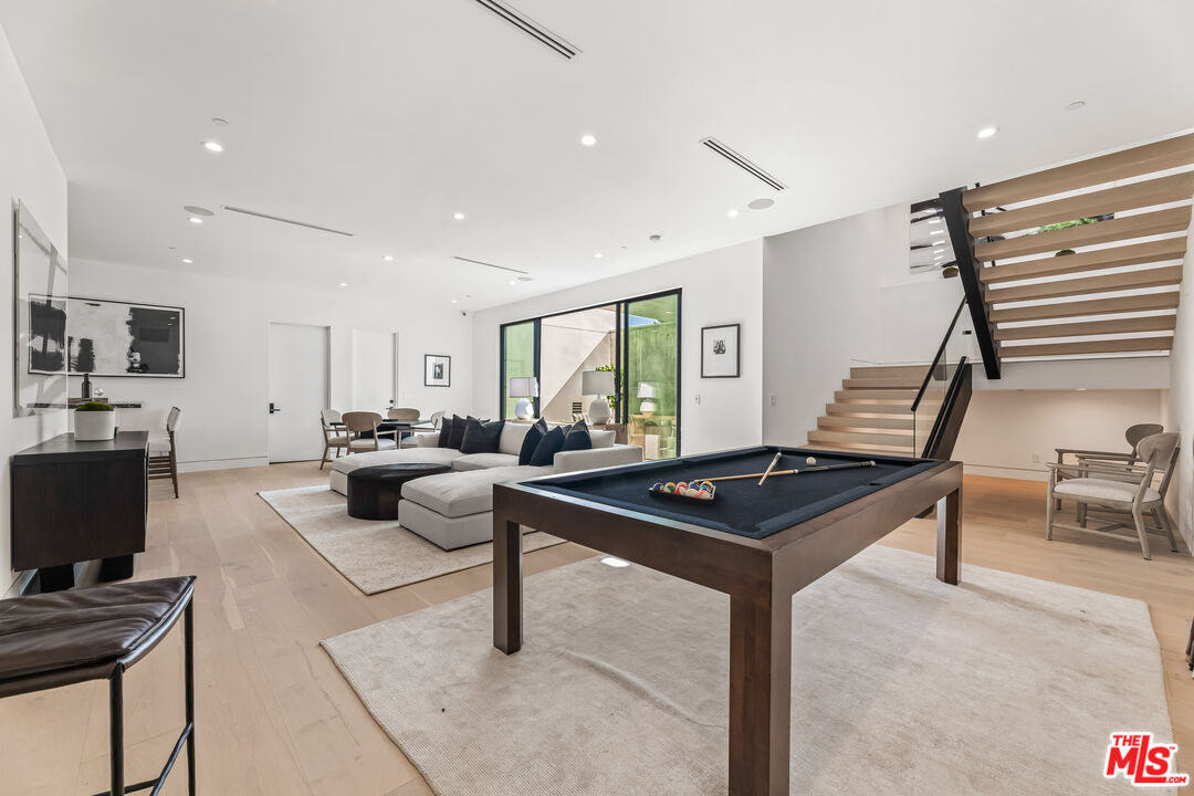 12119 Travis Street Los Angeles, CA 90049 - Photo 20 of 26 a living room with furniture a desk and a flat screen tv