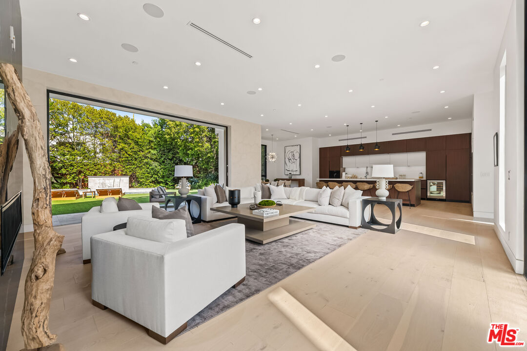 12119 Travis Street Los Angeles, CA 90049 - Photo 2 of 26 a living room with furniture and a large window