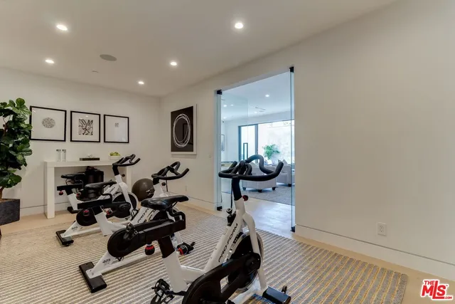 a room with gym equipment and a view of living room
