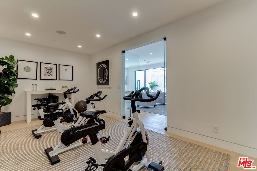 12119 Travis Street Los Angeles, CA 90049 - Photo 25 of 26 a room with gym equipment and a view of living room