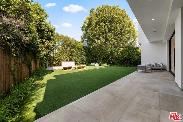a view of a garden with large trees