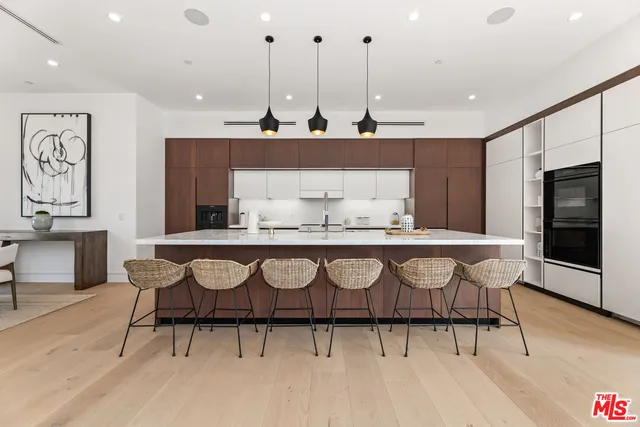 a view of kitchen with stainless steel appliances granite countertop a stove a sink and a refrigerator