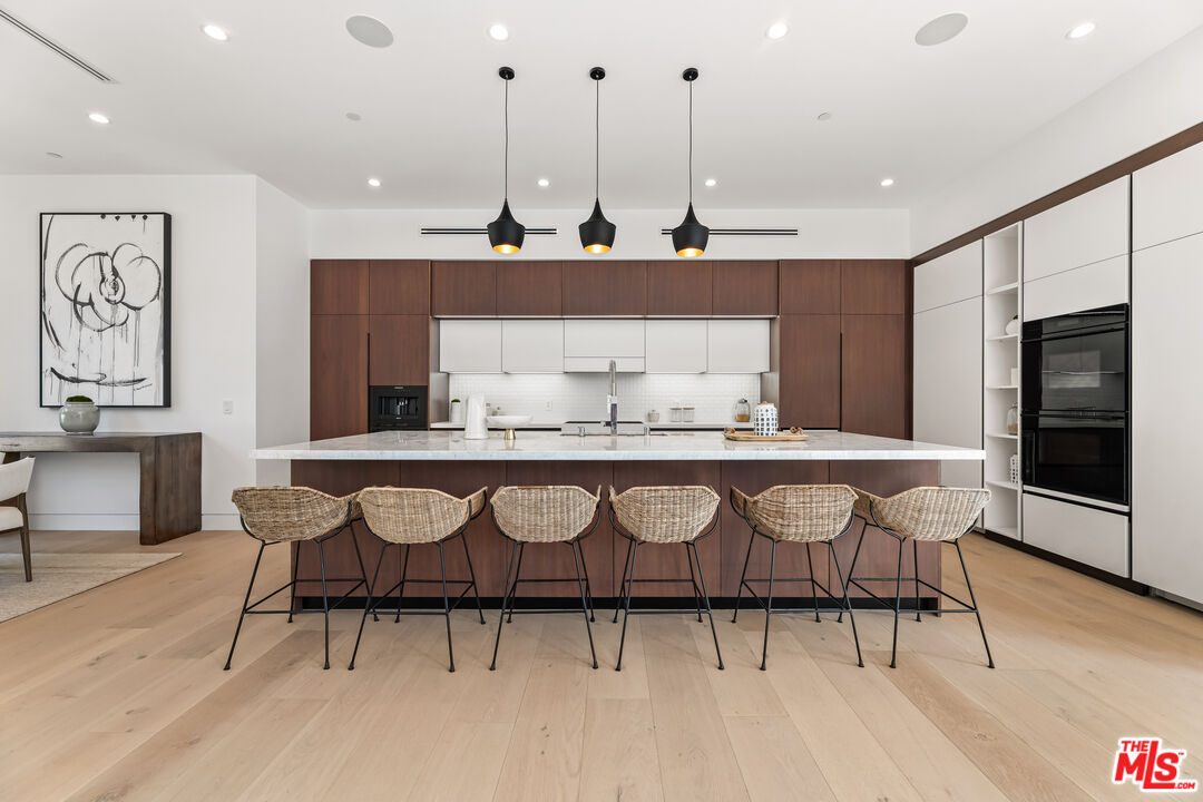 12119 Travis Street Los Angeles, CA 90049 - Photo 3 of 26 a view of kitchen with stainless steel appliances granite countertop a stove a sink and a refrigerator