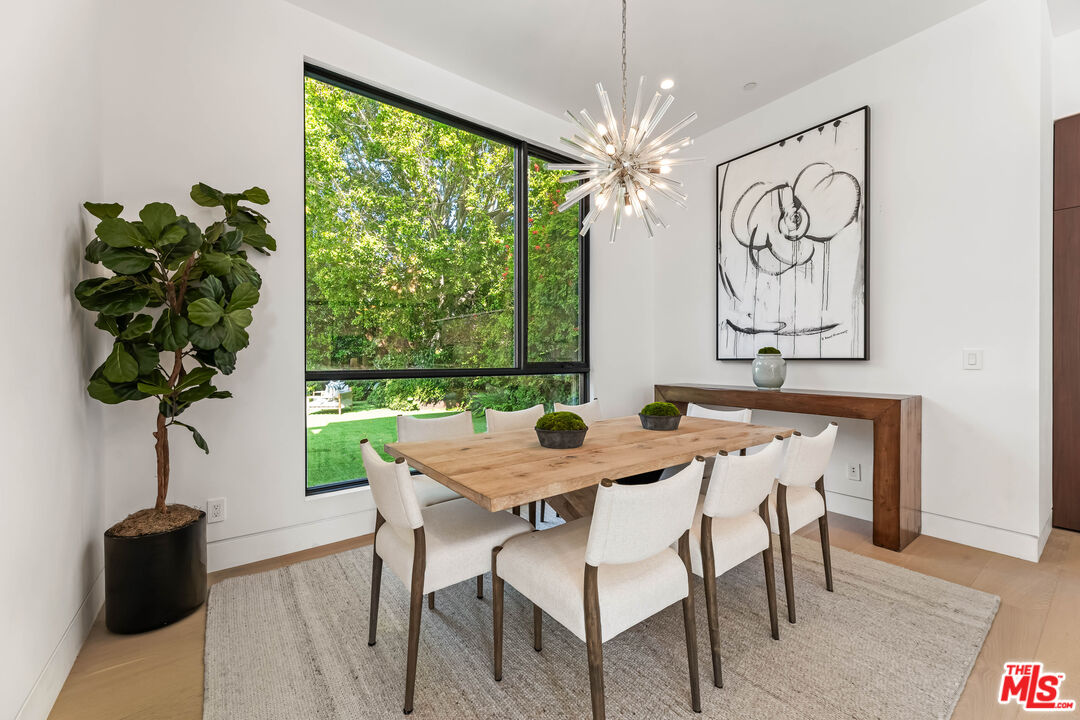 12119 Travis Street Los Angeles, CA 90049 - Photo 4 of 26 a table room with furniture and a large window