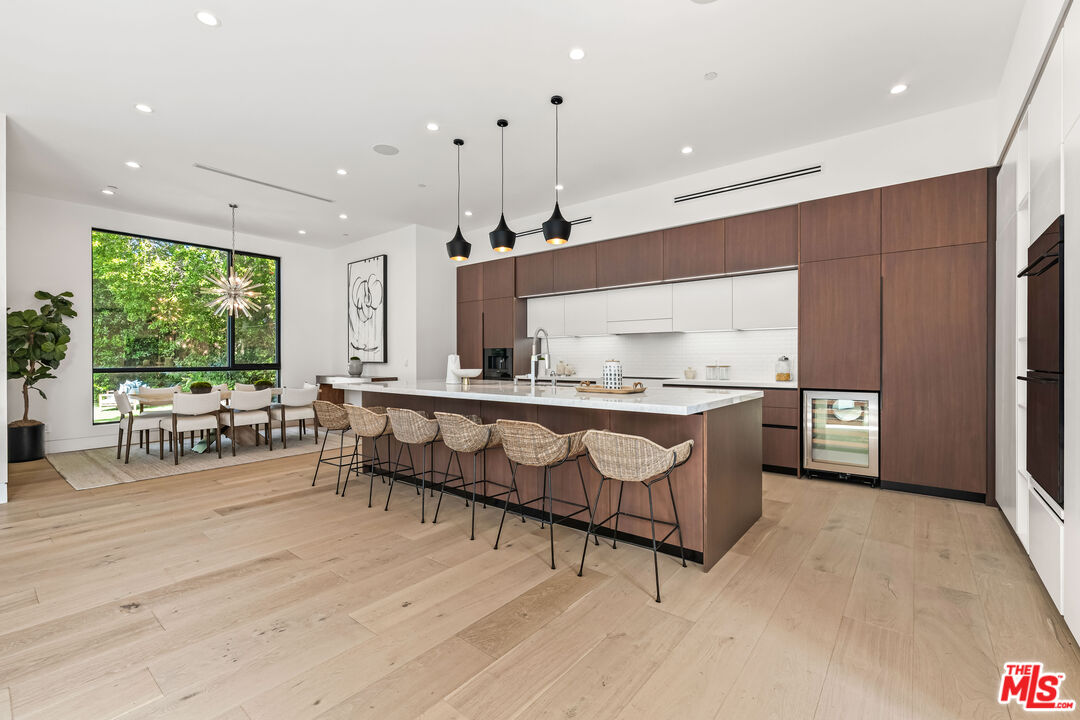 12119 Travis Street Los Angeles, CA 90049 - Photo 6 of 26 a living room with stainless steel appliances kitchen island granite countertop furniture and a large window