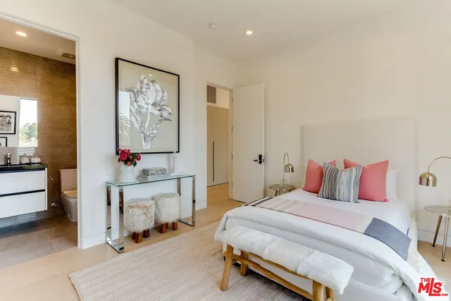 a bedroom with a bed and a desk