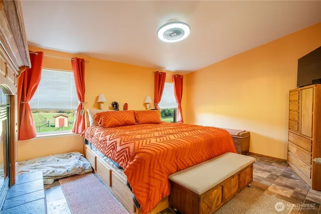 a bedroom with bed and wooden floor