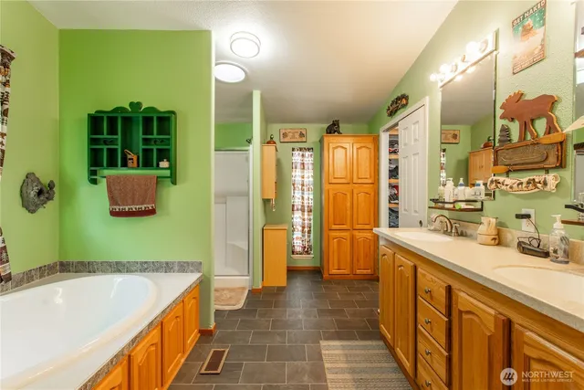 a bathroom with a tub sink and mirror