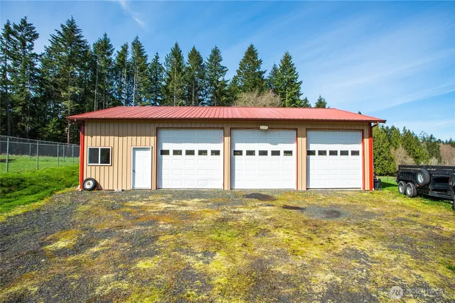 a view of a house with a yard and a garage