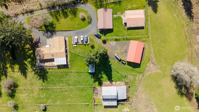 an aerial view of a residential houses with swimming pool