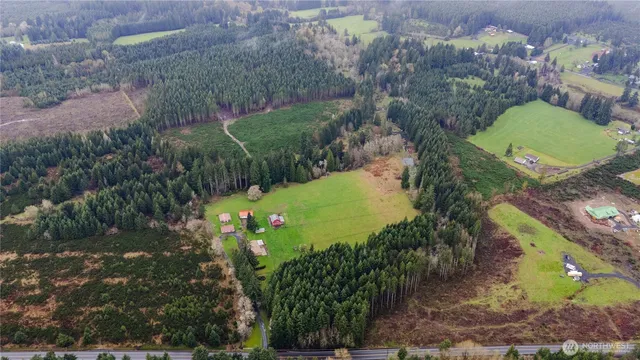 an aerial view of a house with a yard and lake view