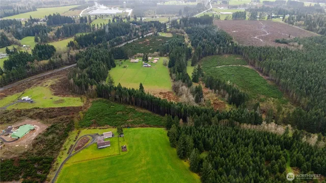 an aerial view of a residential houses with outdoor space and street view