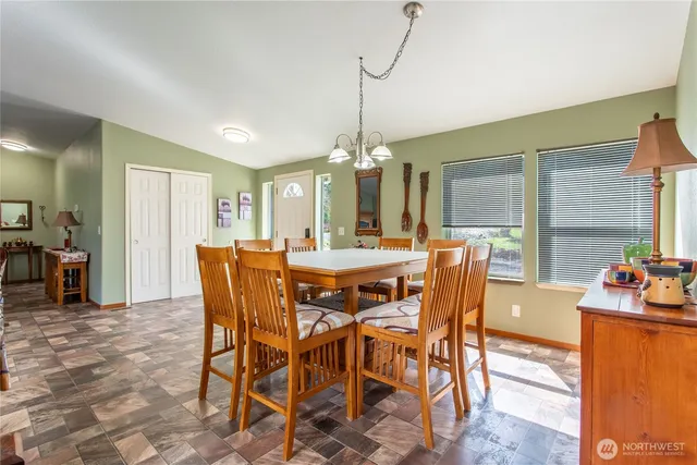 a dining room with furniture window and wooden floor