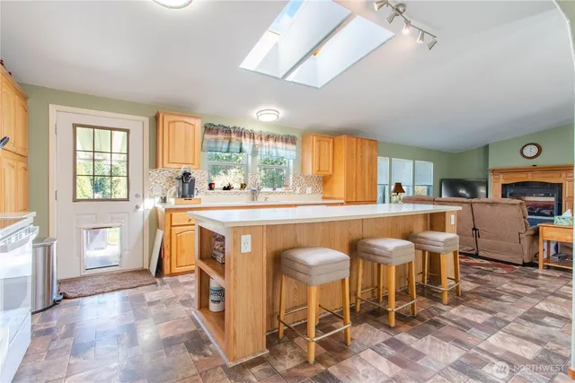 a kitchen with a sink and chairs