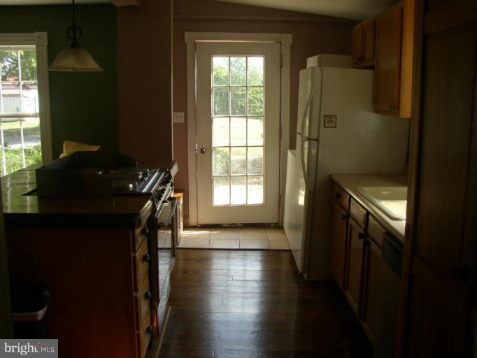 933 Guard Hill Road Middletown, VA 22645 - Photo 20 of 26 a hallway with wooden floor a bathroom