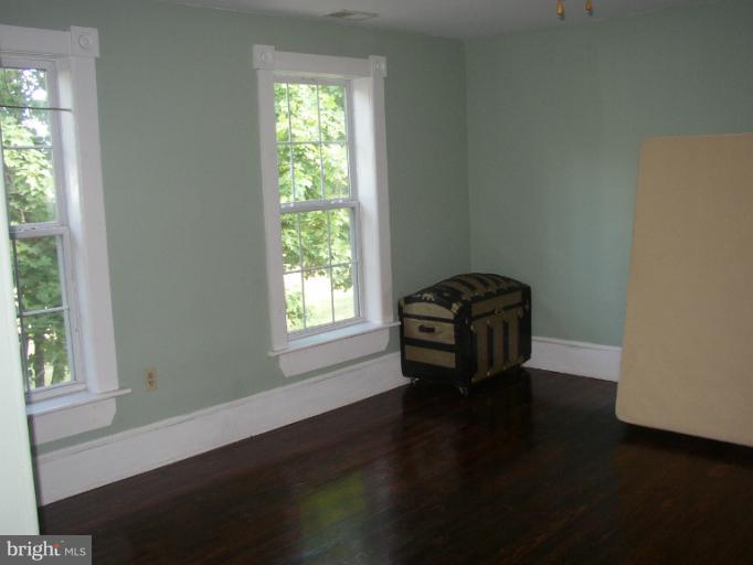 933 Guard Hill Road Middletown, VA 22645 - Photo 26 of 26 a room with a window and wooden floor