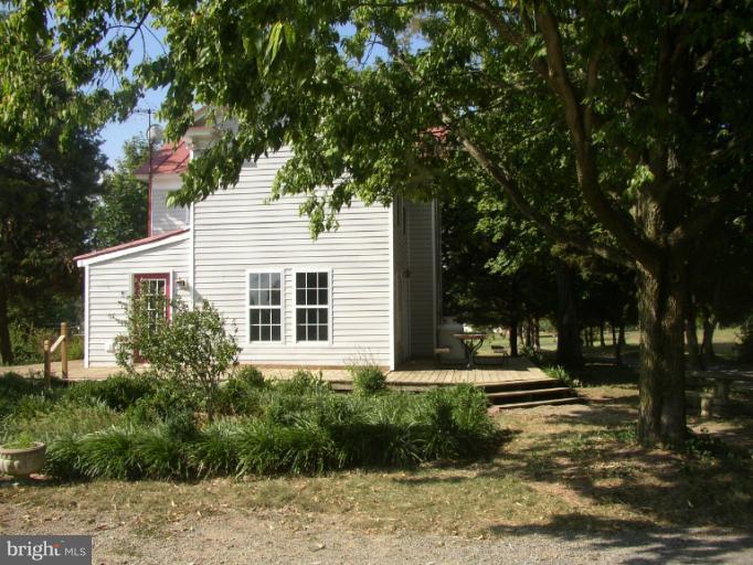 933 Guard Hill Road Middletown, VA 22645 - Photo 4 of 26 a front view of a house with a yard