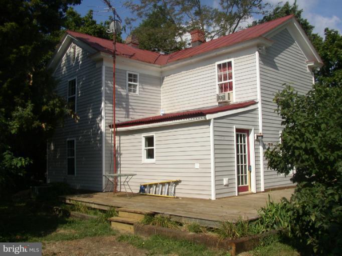 933 Guard Hill Road Middletown, VA 22645 - Photo 6 of 26 a view of a house with backyard and a garden