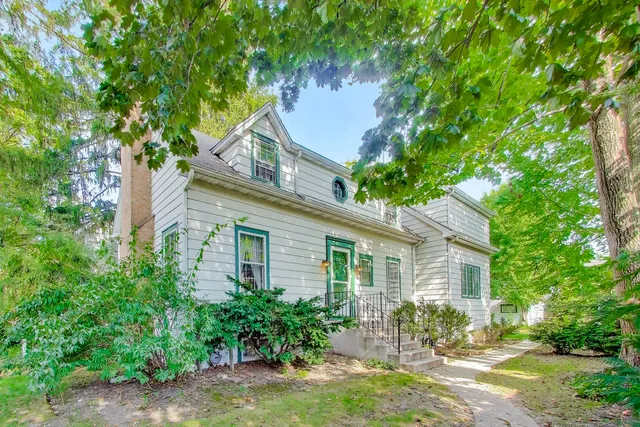 a backyard of a house with outdoor seating and trees