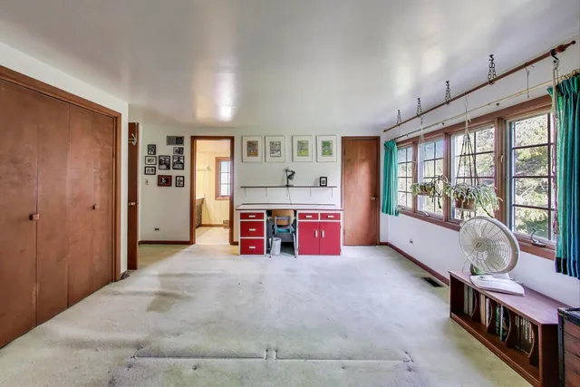 a spacious bedroom with a bed and a large window