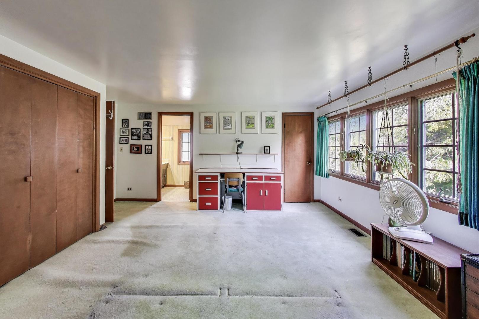 2113 Forestview Road Evanston, IL 60201 - Photo 11 of 18 a spacious bedroom with a bed and a large window