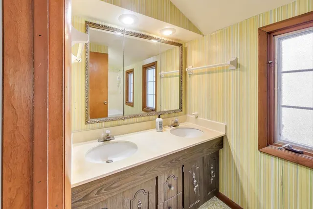 a bathroom with a double vanity sink and a mirror