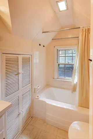 a white bath tub sitting next to a white sink