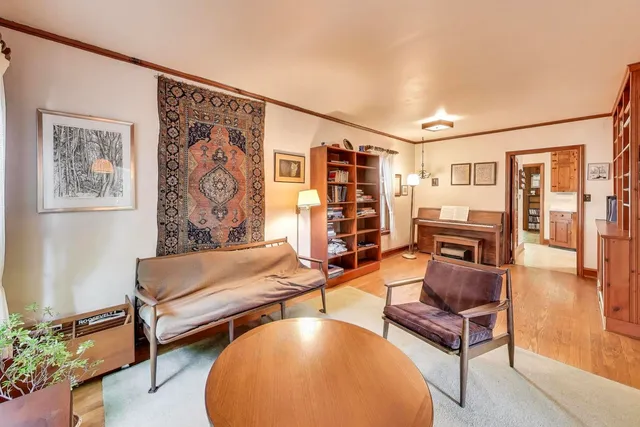 a living room with furniture and a wall painting