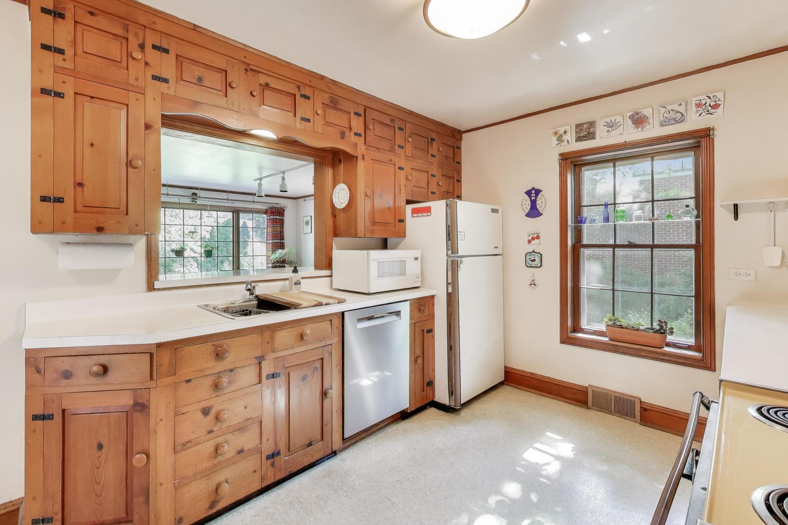 2113 Forestview Road Evanston, IL 60201 - Photo 7 of 18 a kitchen with refrigerator and window