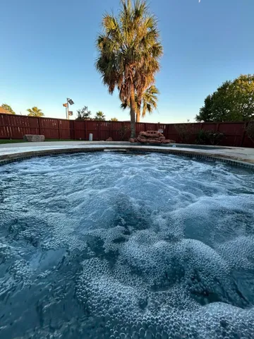 a view of a room with wooden floor staircase and a kitchen
