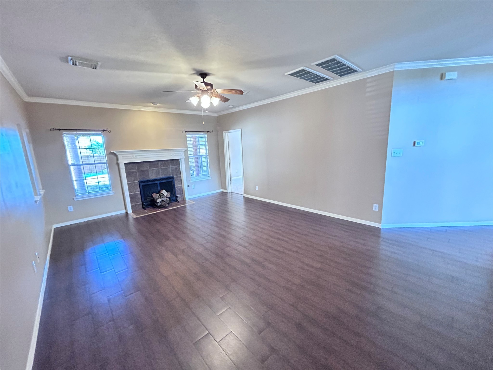 3411 Bay Breeze Drive Seabrook, TX 77586 - Photo 15 of 46 an empty room with wooden floor a fireplace and a window