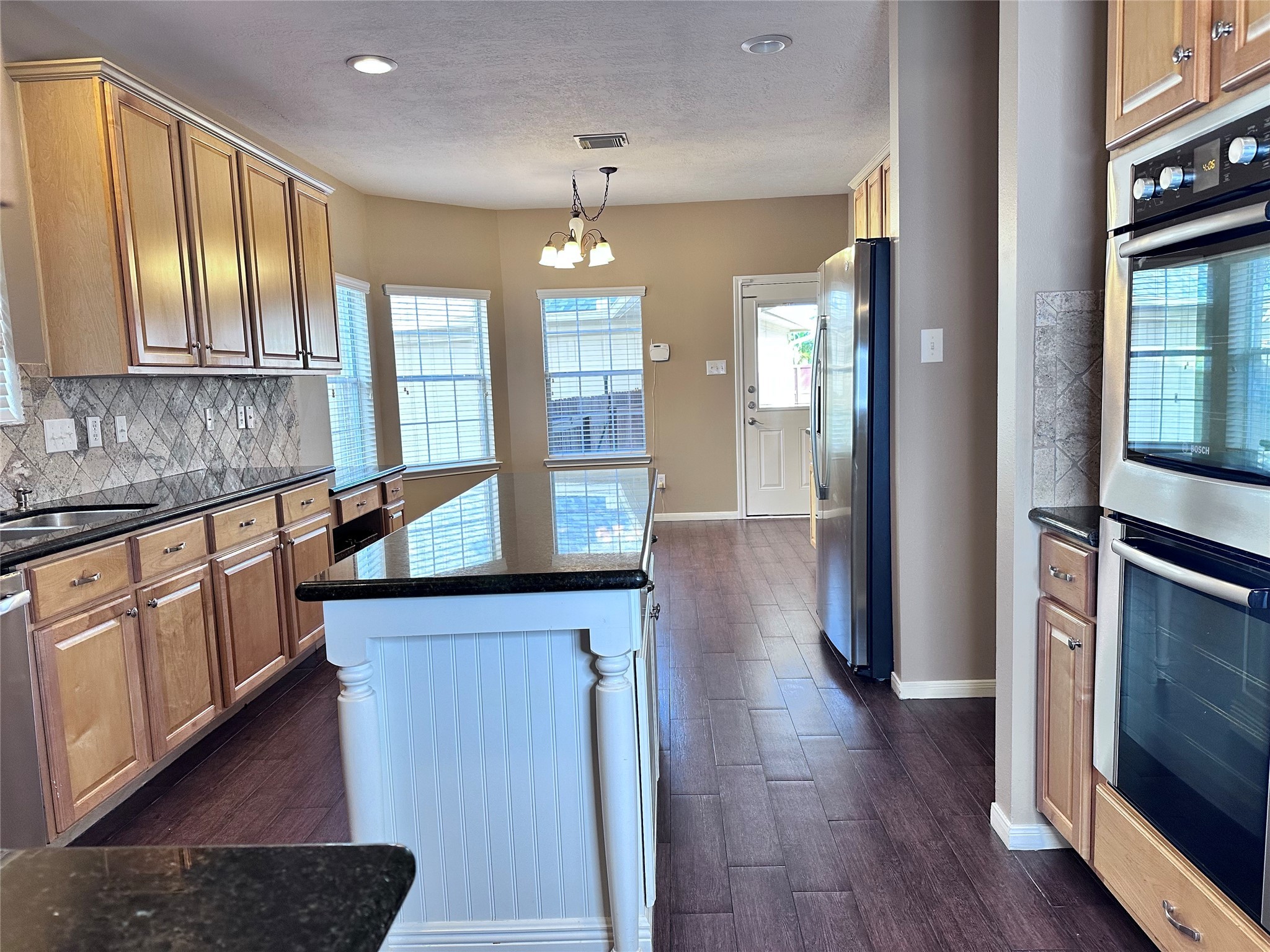 3411 Bay Breeze Drive Seabrook, TX 77586 - Photo 6 of 46 a open kitchen with stainless steel appliances granite countertop a refrigerator a sink dishwasher a stove and white countertops with wooden floor