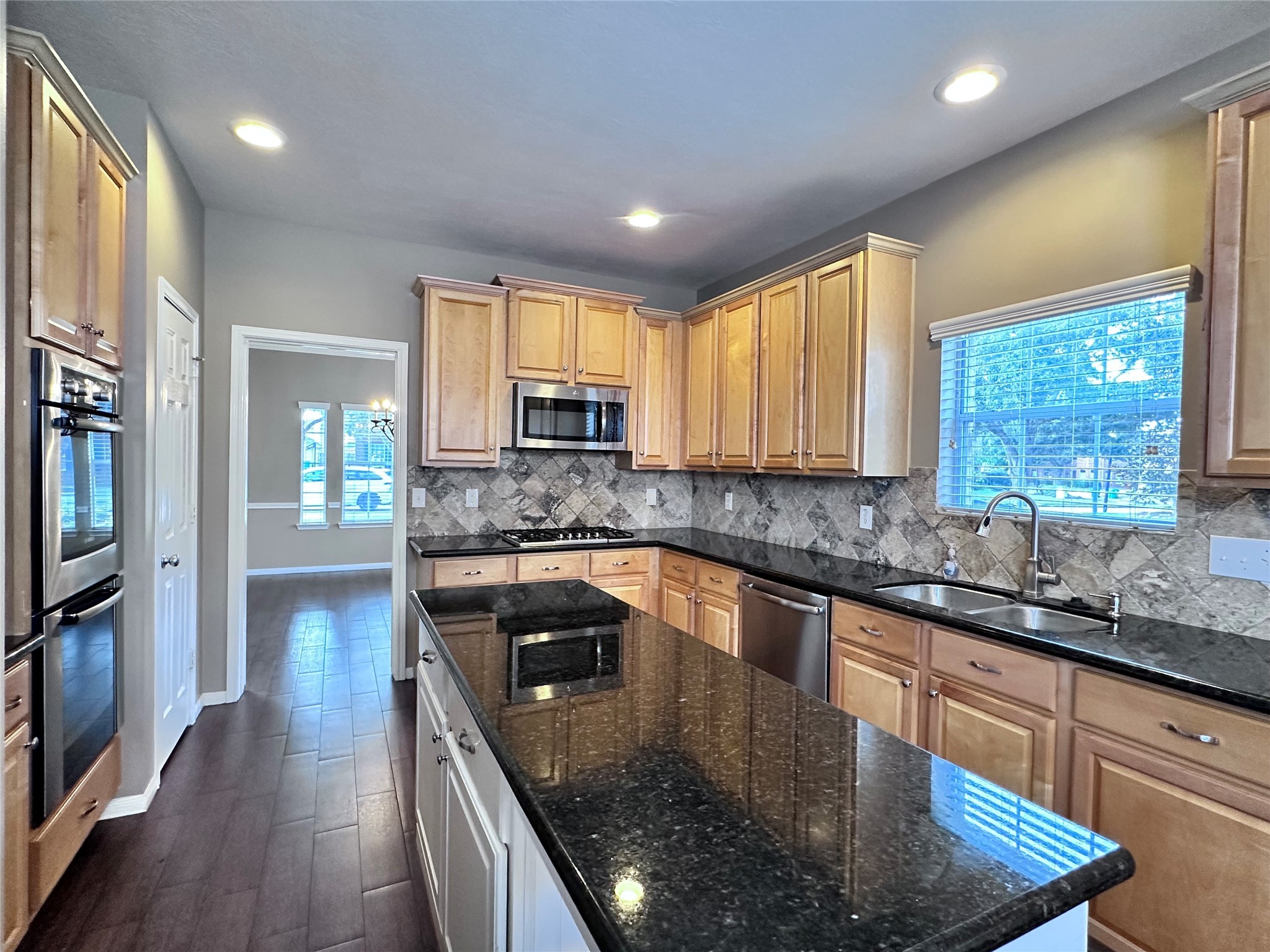 3411 Bay Breeze Drive Seabrook, TX 77586 - Photo 7 of 46 a kitchen with stainless steel appliances granite countertop a sink stove and microwave
