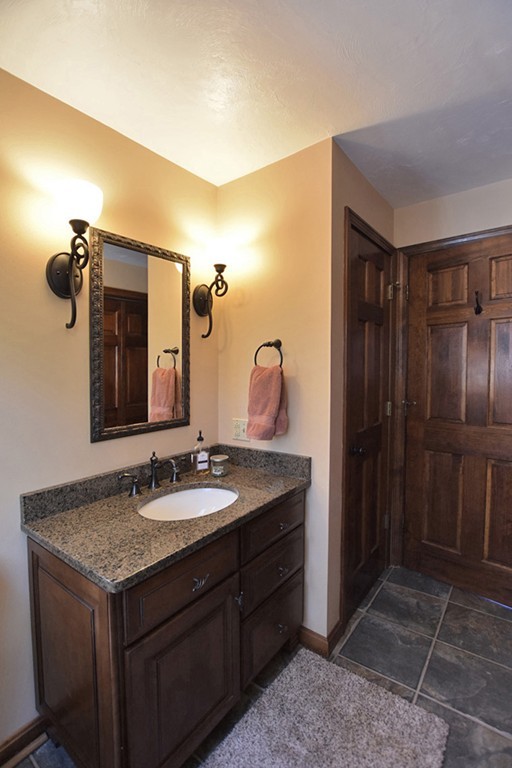 7 Rufus Putnam Place Rutland, MA 01543 - Photo 13 of 24 a bathroom with a granite countertop sink and a mirror