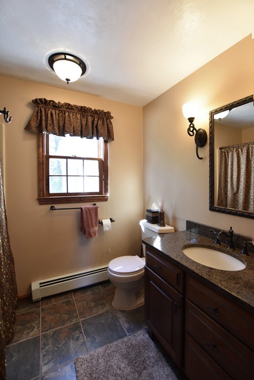 7 Rufus Putnam Place Rutland, MA 01543 - Photo 14 of 24 a bathroom with a granite countertop sink a toilet and a mirror