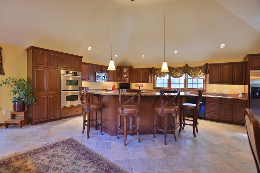 7 Rufus Putnam Place Rutland, MA 01543 - Photo 4 of 24 a kitchen with stainless steel appliances granite countertop a table chairs and a refrigerator