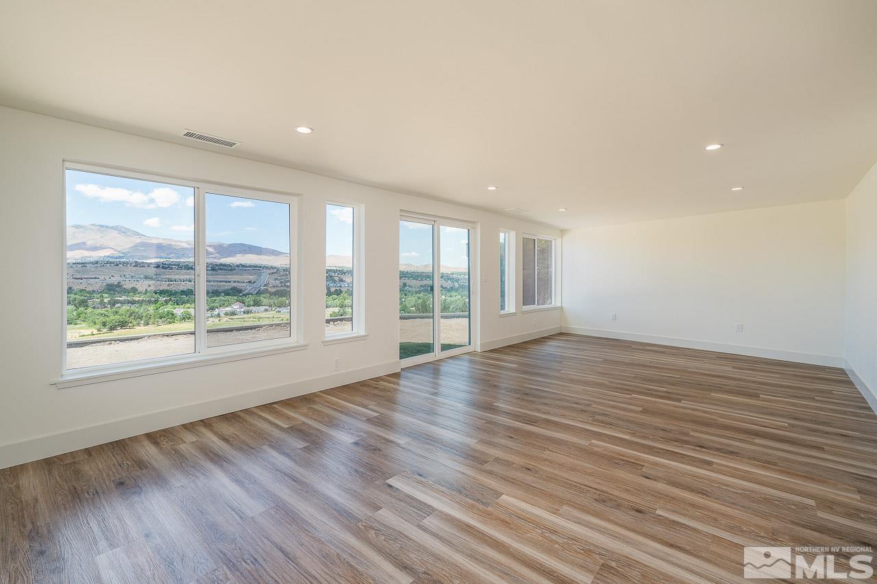 3145 Heatheridge Lane Reno, NV 89509 - Photo 29 of 39 a view of an empty room with wooden floor and a window