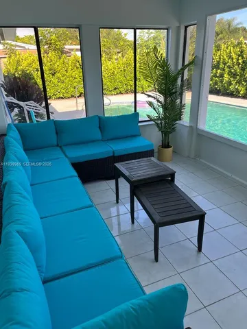 a living room with furniture and a large window